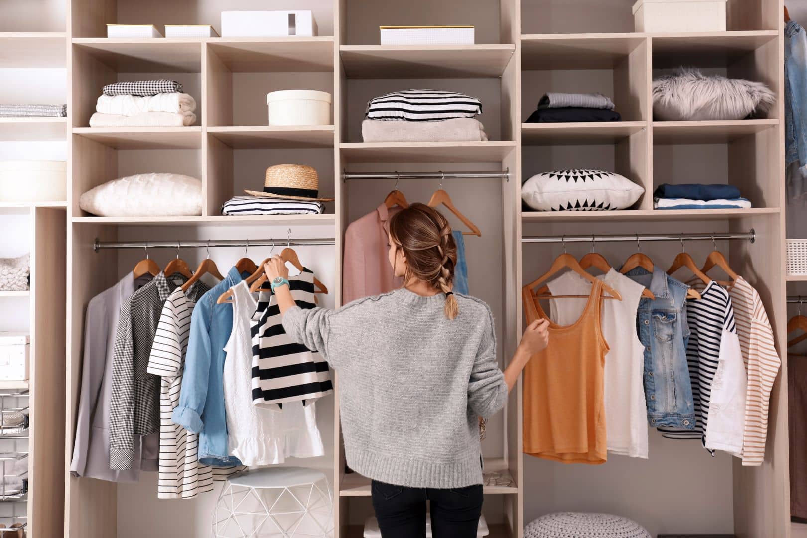 photo of person organizing their bedroom closet