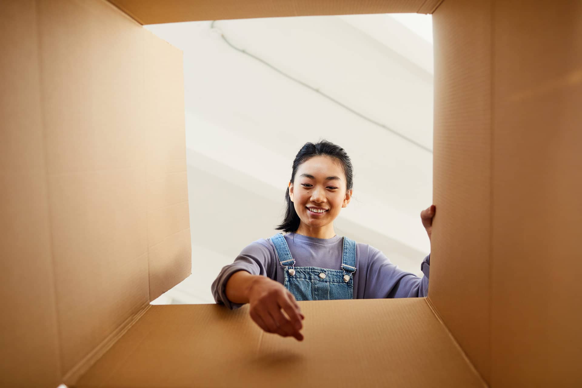 photo of person packing boxes to downside home in calgary